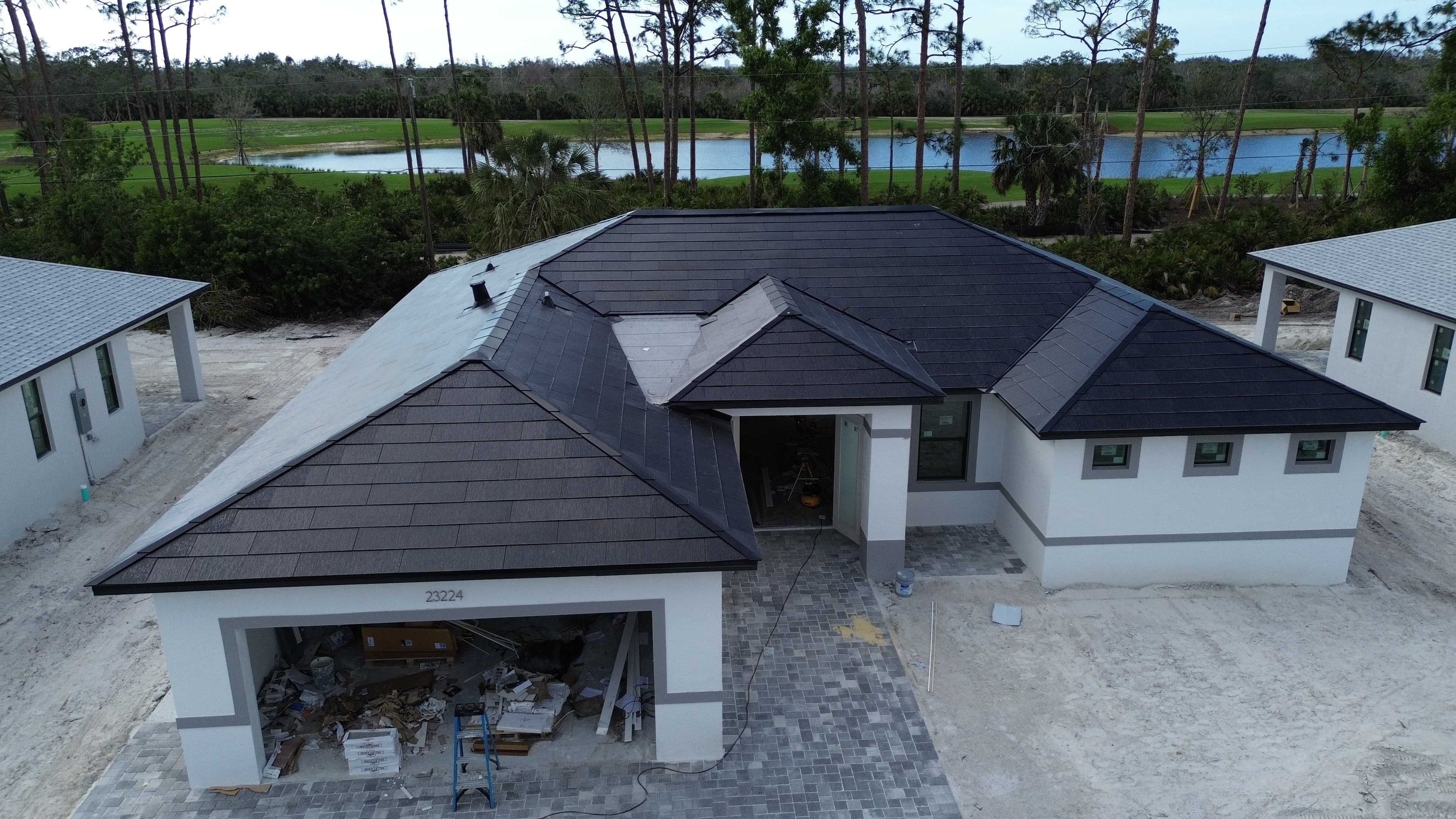 Construction aerial showing multiple homes with solar roofs